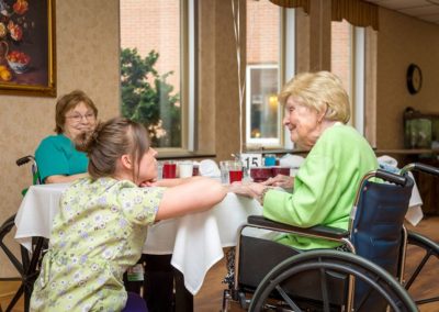Assisted living nurse spending time with senior residents