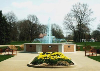 View of fountain with benches and flowers around it