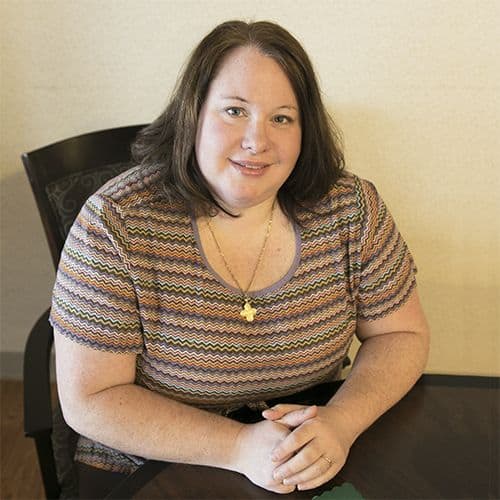 Middle-aged Women sitting in chair and smiling