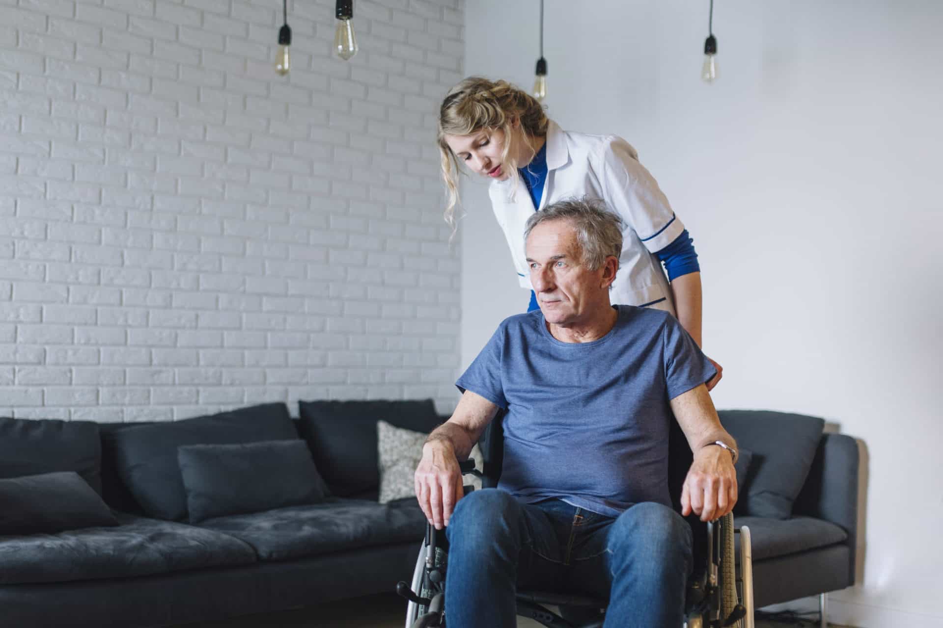 Nurse pushing old man in wheelchair