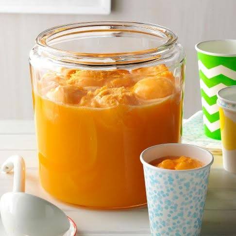 A large Jar filled with Orange Halloween Punch